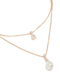 Featuring rose gold plated double layered necklace with cubic zirconia and pearl close up view - link has visual effect only