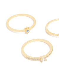 Crafted from gold plated material, celestial rings with blue cubic zirconia moon and star accents in a 5-pack side detail view - link has visual effect only