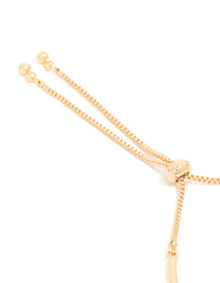Showcasing gold cubic zirconia bow charm toggle bracelet closure detail view - link has visual effect only