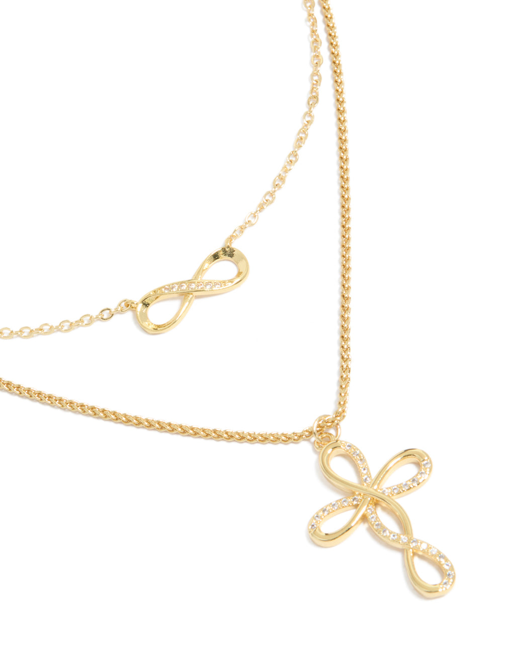 Showcasing a gold plated cubic zirconia layered necklace with infinity and cross close up view