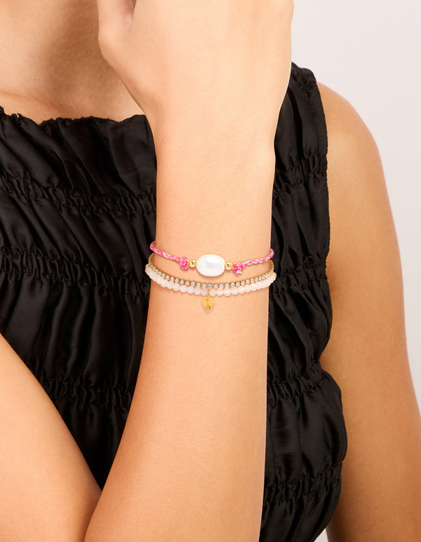Designed with waterproof stainless steel tennis bracelet featuring heart, beads with cubic zirconia, cord, and freshwater pearl accents in pink, white, and gold plated finish on wrist view