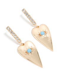 Discover these gold huggie earrings featuring heart with blue evil eye detailing and diamante embellishments front view - link has visual effect only