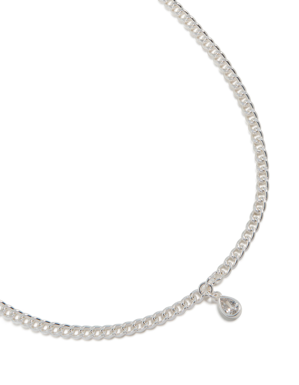 Showcasing a silver pear diamante drop Cuban link necklace with statement styling close up view