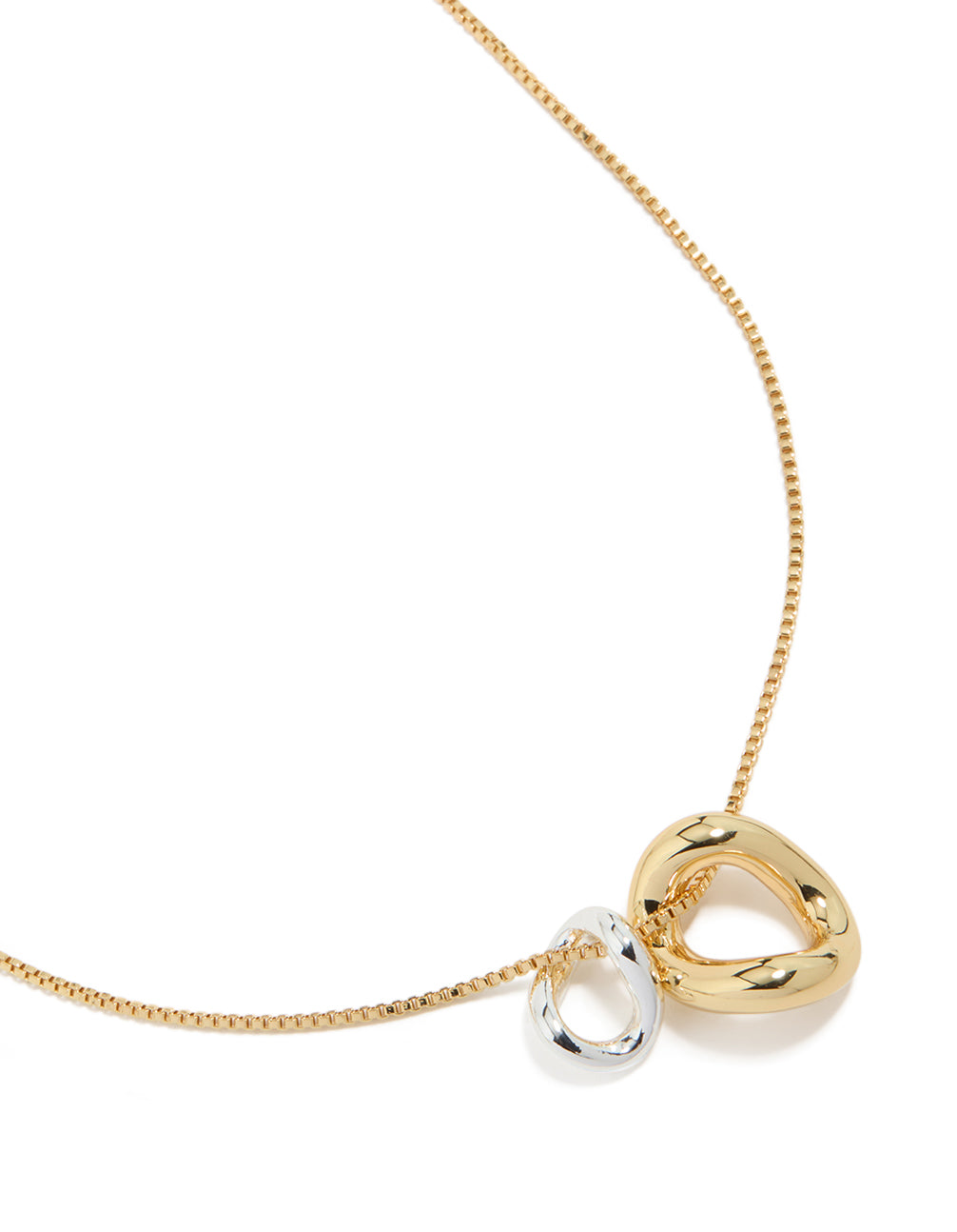 Expertly designed mixed metal small swirl pendant necklace in gold and silver plated materials close up view