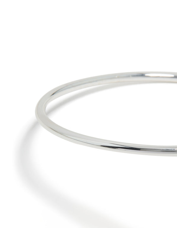Featuring a molten drop arm cuff in silver plated metal with statement design close up view
