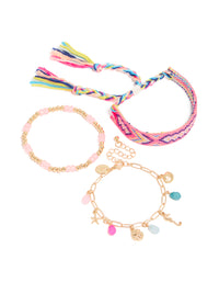 Featuring gold pink beaded and sea charm bracelets in a 3-pack with ocean and tassel details crafted from cord front view - link has visual effect only