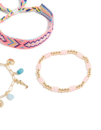 Displaying gold pink beaded and sea charm bracelets in a 3-pack with ocean and tassel details crafted from cord closure detail view - link has visual effect only