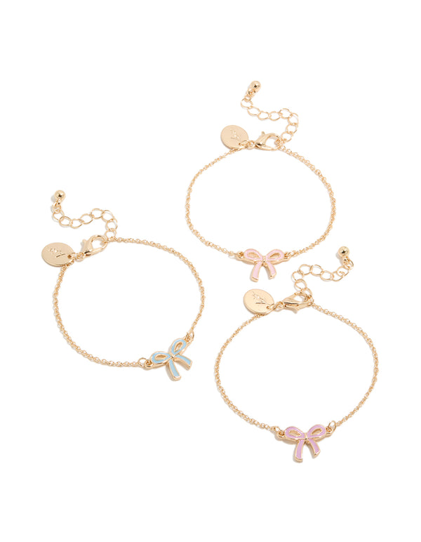 Charming set of kids gold enamel bow bracelets featuring pink and light blue in a 3-pack front view