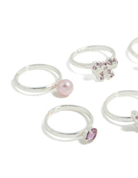 Crafted from silver, kids diamante bow, pearl and butterfly rings in pink and plum close up view - link has visual effect only