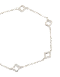 Showcasing a sterling silver statement flower charms bracelet in silver close up view - link has visual effect only