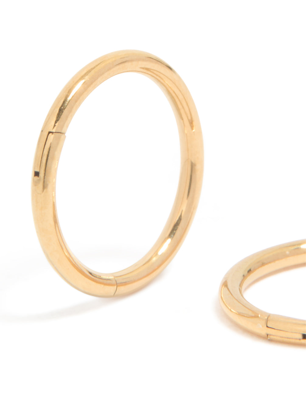 Highlighting chunky hoop sleeper earrings crafted from gold plated titanium close up view