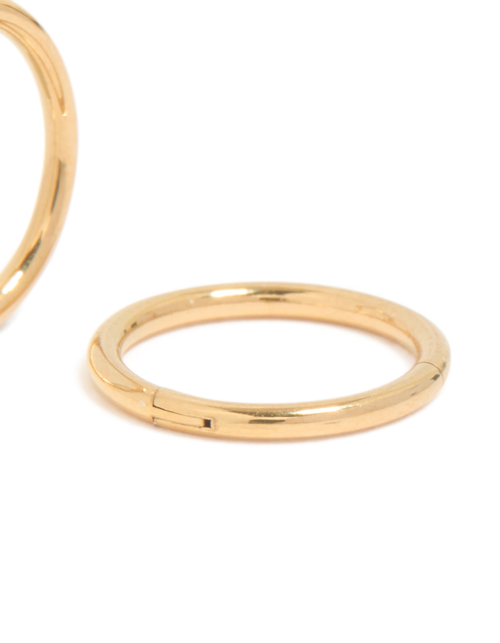Featuring chunky hoop sleeper earrings with gold plated titanium finish post detail view