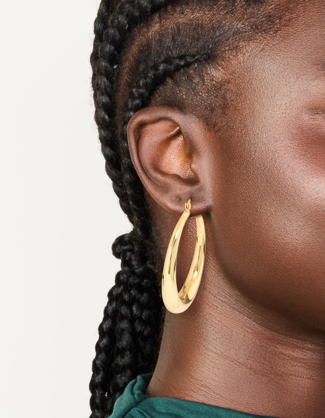 Crafted from gold plated material, thick thin hoop earrings with closure on ear view