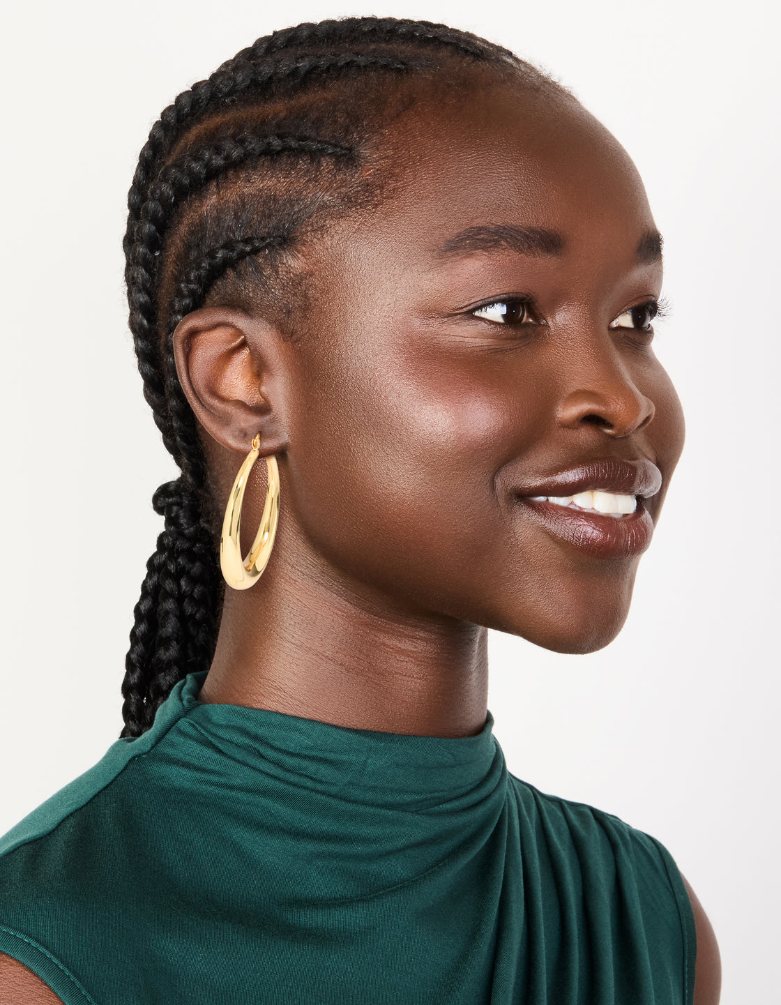 Featuring gold plated thick thin hoop earrings with closure on model view