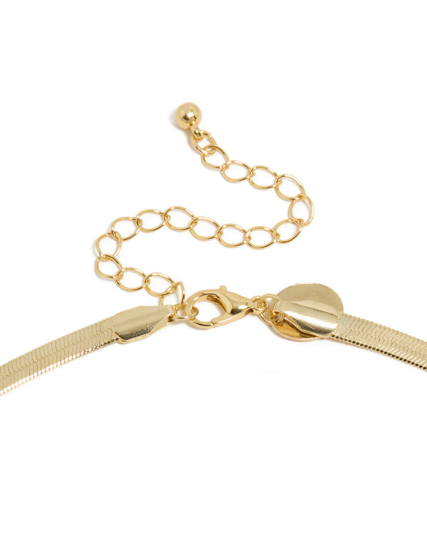 Highlighting a gold plated cubic zirconia necklace with snake chain and lobster clasp detail view
