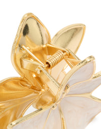 Crafted from enamel, this floral tropical stem hair claw clip in gold and cream detail view - link has visual effect only