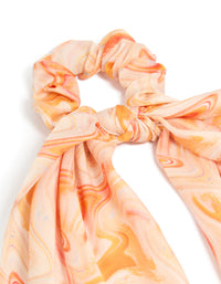 Showcasing an abstract print in peachpuff, darkorange, this orange marbled fabric scarf scrunchie delivers statement style side view - link has visual effect only