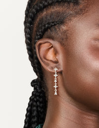 Stunning floral cubic zirconia drop earrings in silver plated finish with statement style on ear view - link has visual effect only