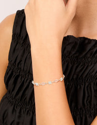 Crafted from silver plated material, this oval and round cubic zirconia tennis toggle bracelet is shown on wrist view - link has visual effect only