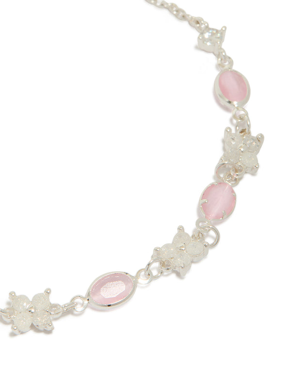 Featuring floral and charms, this silver plated oval cubic zirconia toggle bracelet highlights pink and clear stone detailing close up view