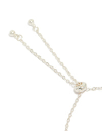 This silver plated oval toggle bracelet with floral and charms features cubic zirconia in pink and clear stone closure detail view - link has visual effect only