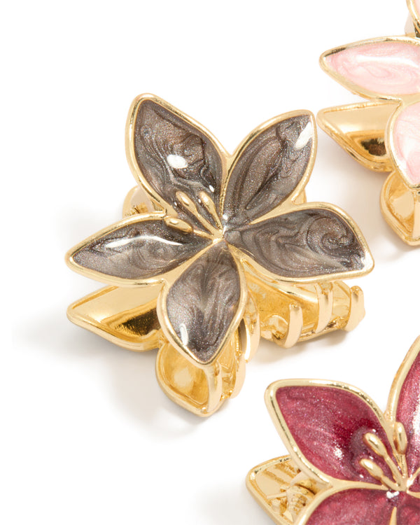 Crafted from gold pink burgundy enamel frangipani claw clips in a 4-pack featuring floral design and glitter accents detail view