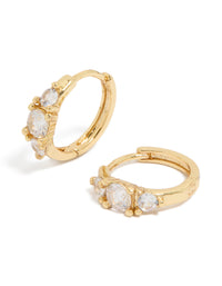 Discover these gold plated mixed sized cubic zirconia mini huggie earrings featuring huggie closure front view - link has visual effect only