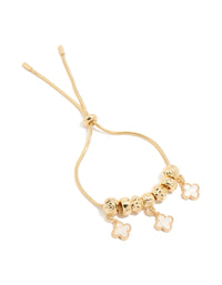 Crafted from gold plated metal, this beaded bracelet featuring white genuine shell flower inlay charms and toggle closure front view - link has visual effect only