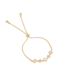 This gold plated bracelet features floral details with cubic zirconia and plain white inlay, complete with a toggle closure front view - link has visual effect only