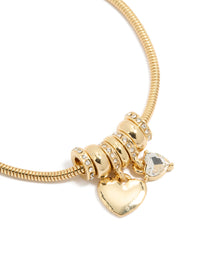 Featuring a gold plated cubic zirconia chunky heart charm toggle bracelet with statement design close up view - link has visual effect only