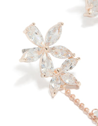 Showcasing rose gold plated cubic zirconia flower station drop earrings with beaded charm details and floral pattern close up view - link has visual effect only