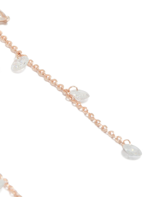 Showcasing rose gold plated cubic zirconia flower station drop earrings with beaded charm details and floral pattern close up view