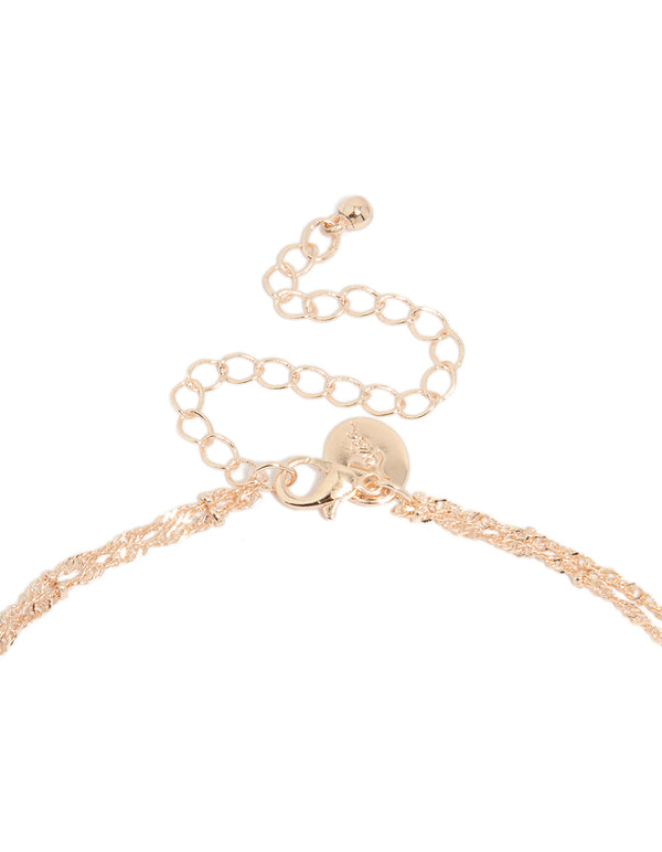 Beautiful rose gold plated cubic zirconia bezel set layered chain Y-necklace with statement styling clasp detail view