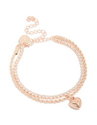 Showcasing a rose gold plated cubic zirconia tennis and heart layered bracelet with charm detail front view - link has visual effect only