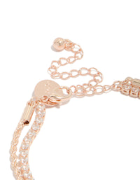 Featuring a rose gold plated cubic zirconia tennis and heart layered bracelet with charm detail closure detail view - link has visual effect only