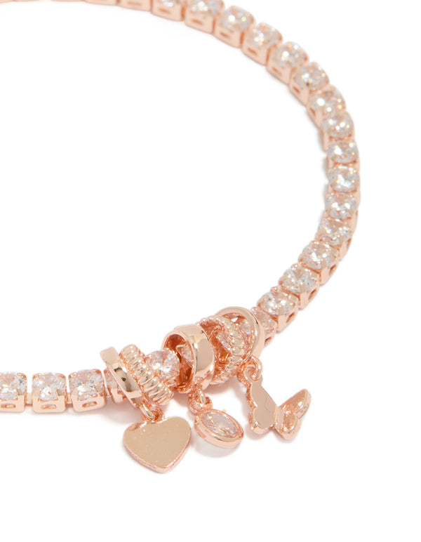 Crafted from rose gold plated cubic zirconia mixed charm tennis bracelet with butterfly and heart charms close up view