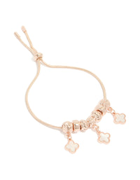 Featuring rose gold plated triple flower charms with beads in a toggle bracelet front view - link has visual effect only