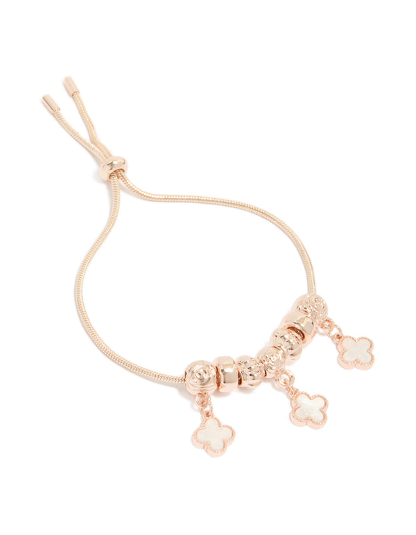 Featuring rose gold plated triple flower charms with beads in a toggle bracelet front view
