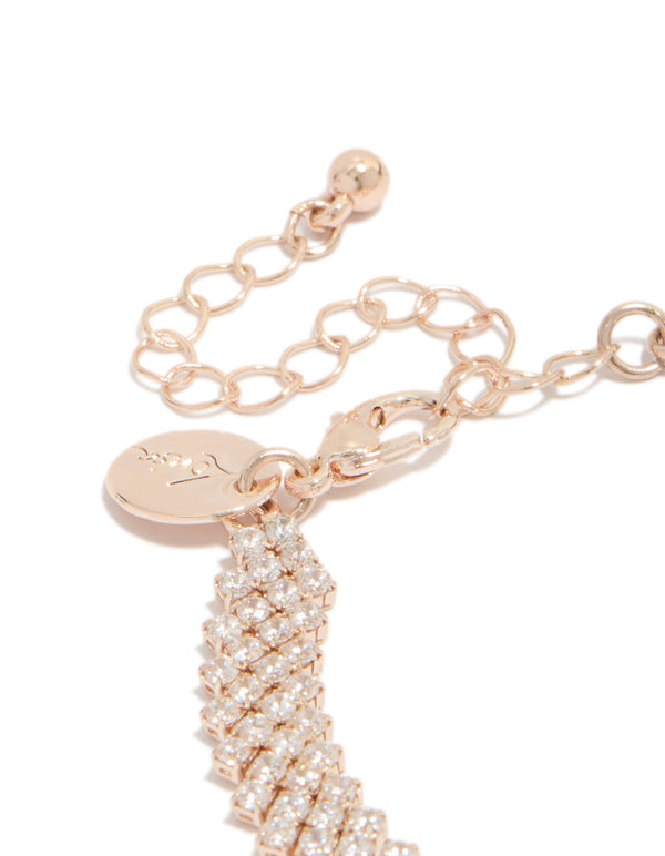 Designed with rose gold plated cubic zirconia diagonal tennis bracelet featuring round stone cut and charm closure detail view