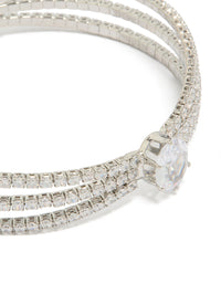 Highlighting a statement wrist cuff featuring cubic zirconia with oval stone cut in silver close up view - link has visual effect only
