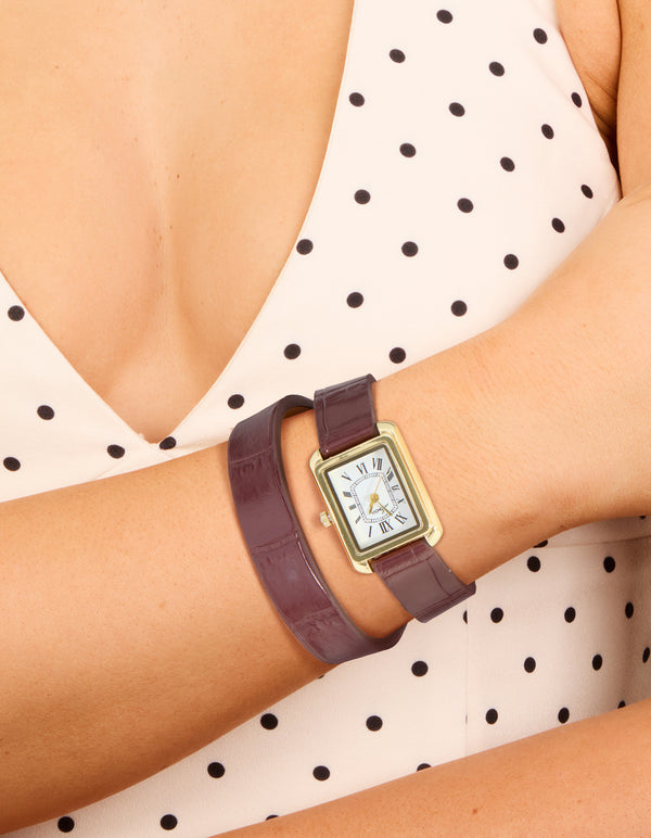Explore a women's analog watch featuring white roman rectangle dial, brown leather strap, and gold PU construction designed for formal occasions on wrist view