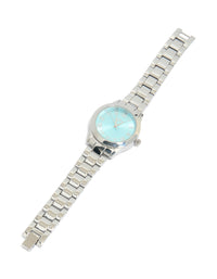 Showcasing a women's watch with roman numeral blue dial, round shape, casual analog design, link band strap in silver front view - link has visual effect only