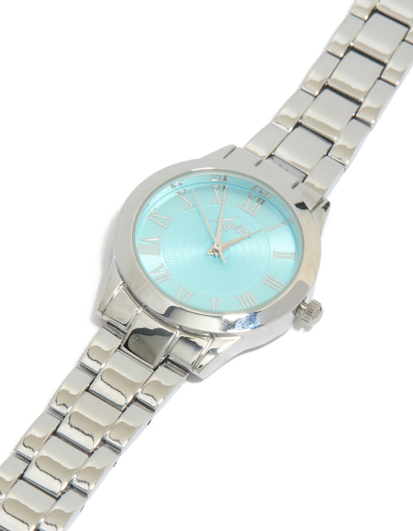Beautifully crafted women's watch featuring roman numeral blue dial with round shape, casual analog design, and link band strap in silver watch face detail view