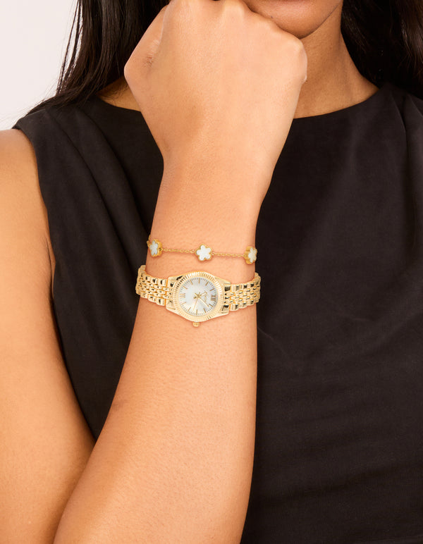 Stylish gold watch and flower bracelet, white dial, roman numerals, round shape, formal occasion design, link band, and analog type on wrist view