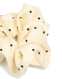 Featuring polka dot pattern in cornsilk and black statement fabric scrunchie side view - link has visual effect only