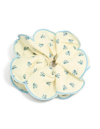 Showcasing a ruffled scrunchie with floral print in ivory, sky blue and teal front view - link has visual effect only