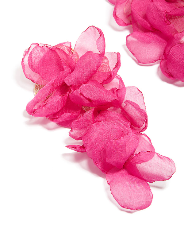 Showcasing statement drop earrings with floral fabric design in hot pink and light pink close up view