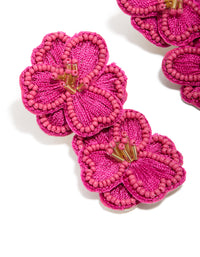 Crafted from statement hot pink fabric beaded double flower drop earrings close up view - link has visual effect only