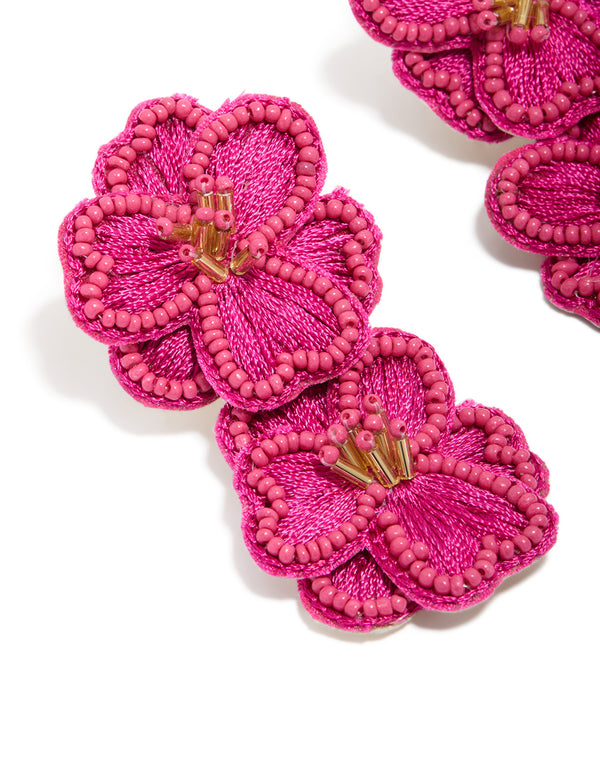 Crafted from statement hot pink fabric beaded double flower drop earrings close up view