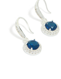 Elegant drop earrings featuring sapphire blue cubic zirconia with halo cut and plated finish close up view - link has visual effect only